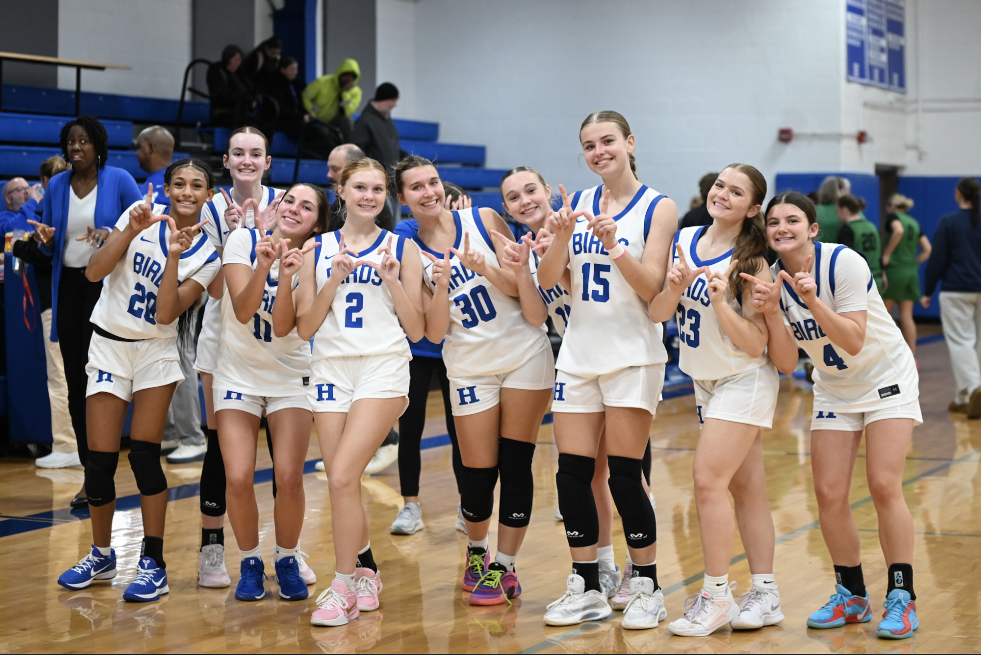 The Highlands girls basketball team holds up "W" after taking down Dayton.