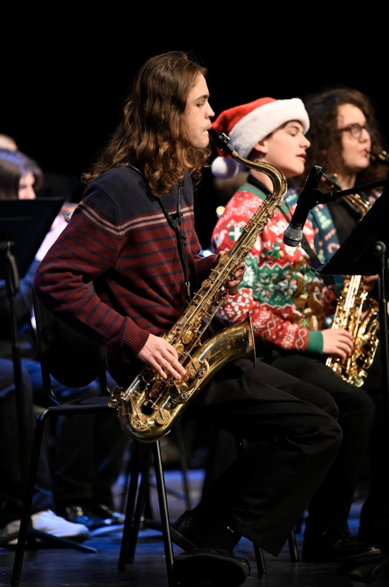 Cole Noah (11) and Warren Huth (11) take on the stage as they play their saxophones.