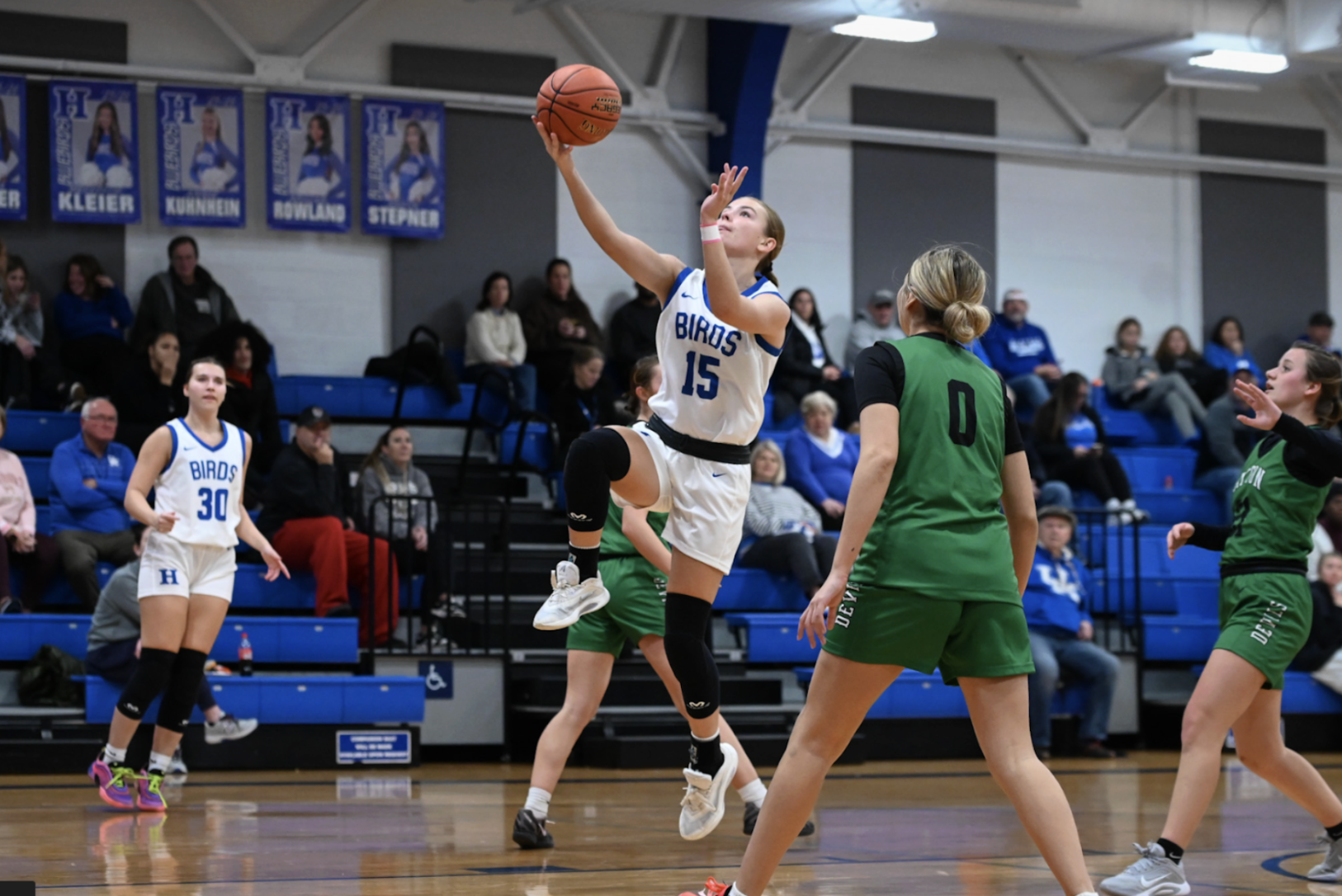 Katie Bucher (12) goes for a layup.