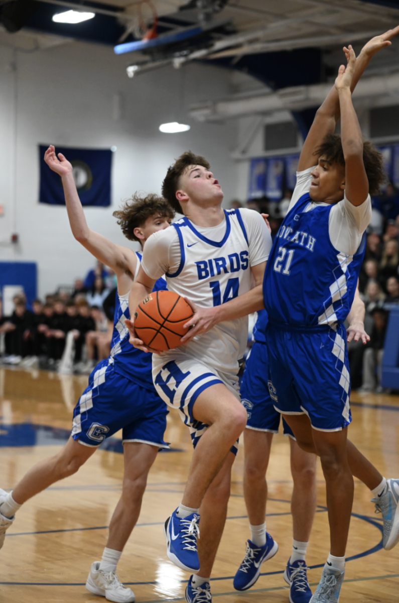 Teddy Krieg (11) goes for a layup with an attempt to score with an outcome of success.