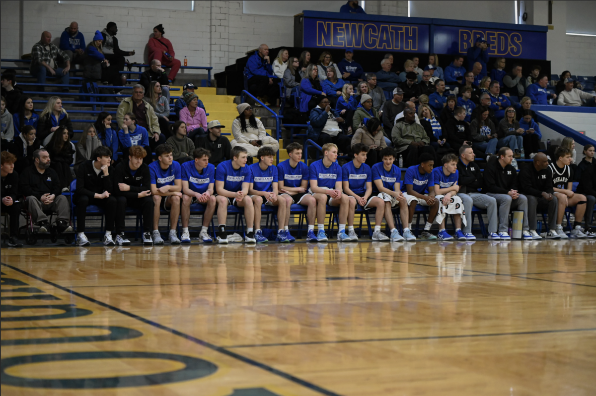 The Highlands' boys basketball team watches the game. "I want to continue to share the ball to my teammates to set them up for up for great opportunities," Charlie Messmer (12) said.