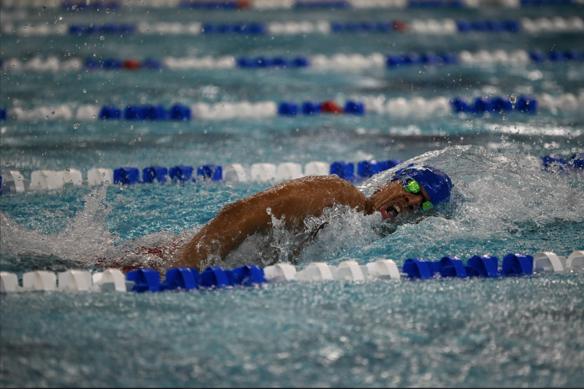 Chanith Abeysinghe (11) breathes during his 100 yard freestyle.
