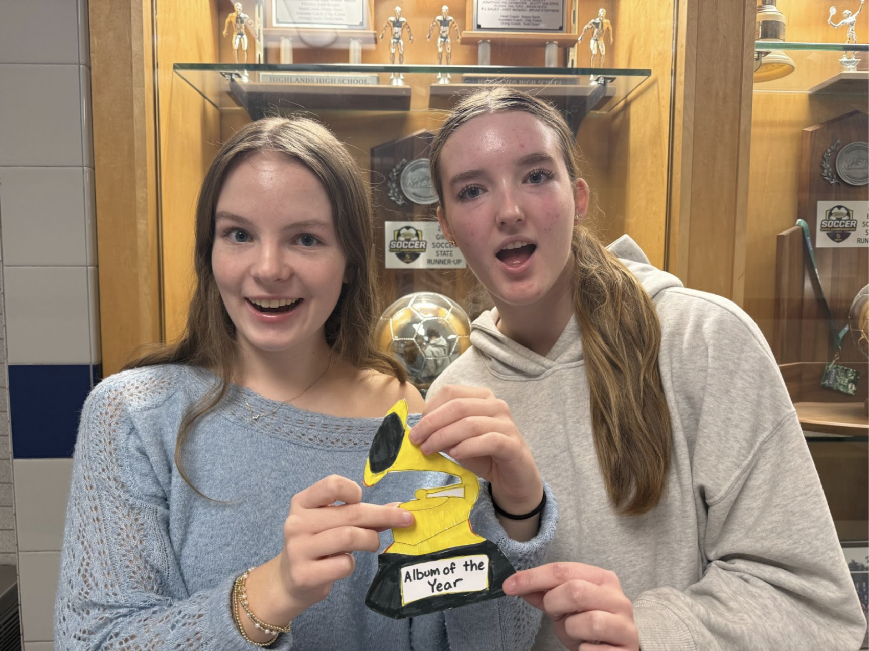 Natalie Abdon (10) and Stella Taylor (10) display Grammy for Album of the Year. 