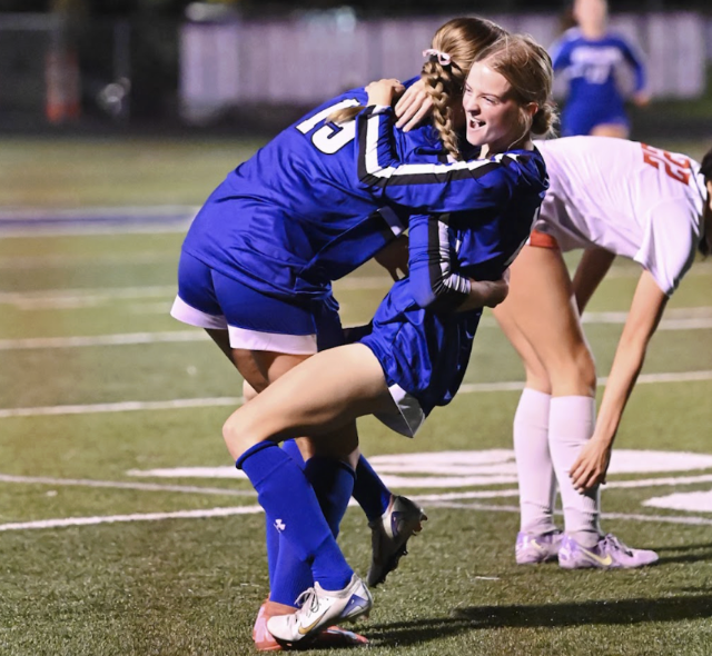 Katie Bucher (12) and Macy Hargis (12) hug after a goal is scored. “Beating any team in the region is always great, but doing it by 4 goals boosted our confidence. It is exactly what we needed going into the game against Notre Dame,” Bucher said. 
