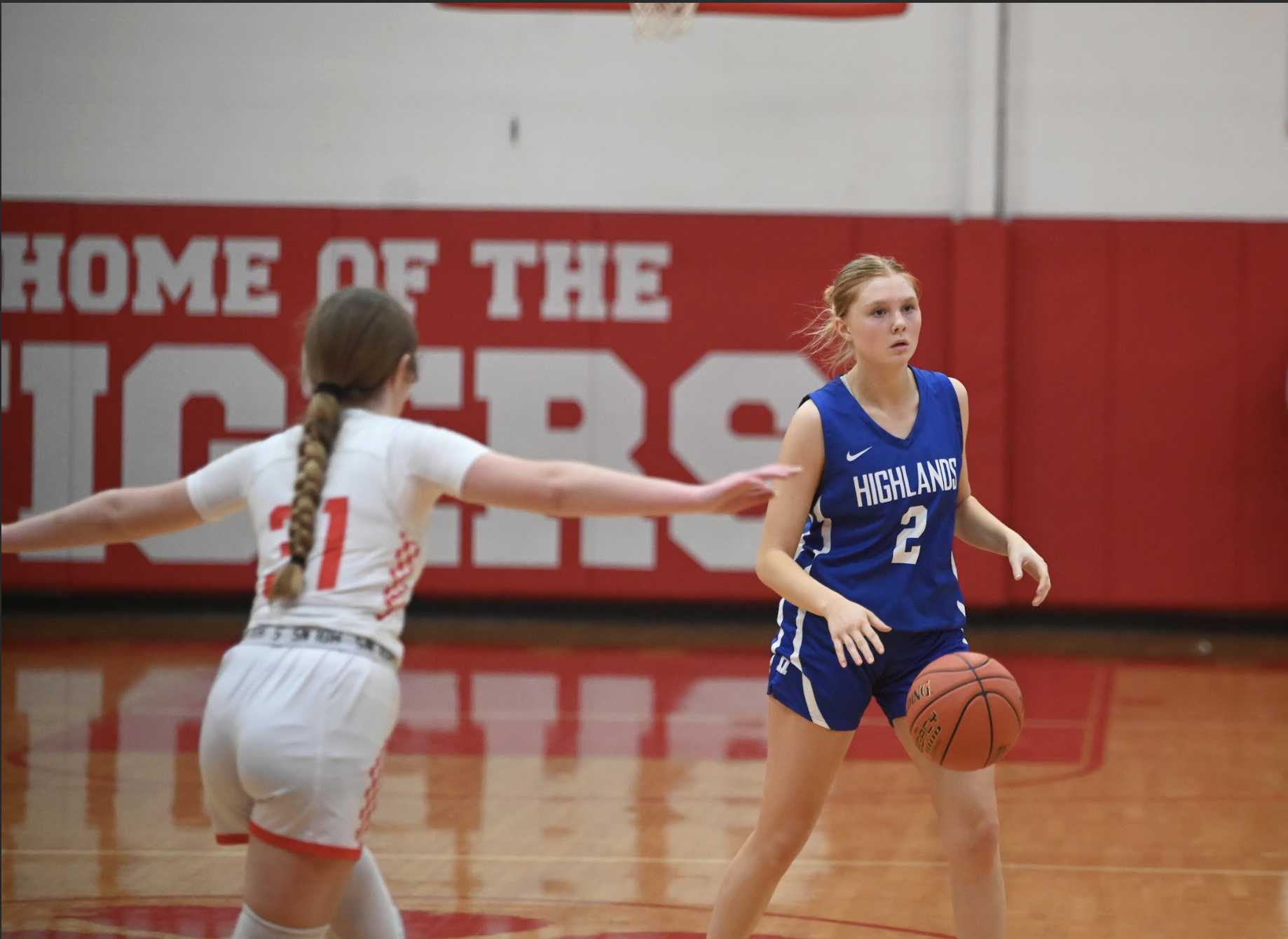 Kaylee Mills (12) drives the ball down the court.
