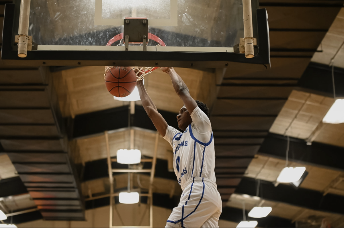 Amil Wimzie (8) dunks the ball into the hoop. "I feel good and confident going into our next district game against Newport," Wimzie (8) said.