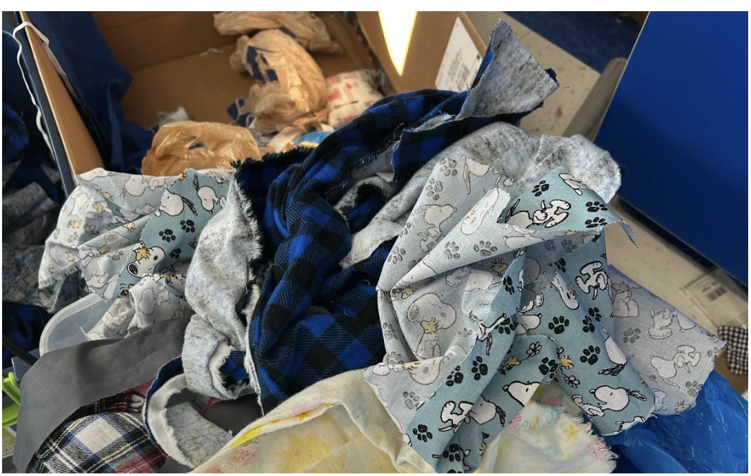 Fabric scraps from the 8th grade sewing projects lay in a basket for future use. 