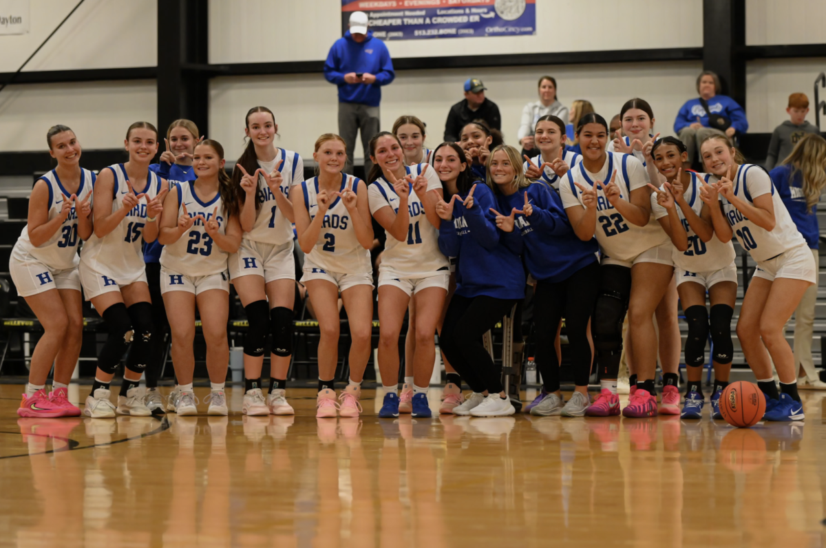 The Highlands' girls basketball team gets together for a photo after they win the 36th District Tournament.