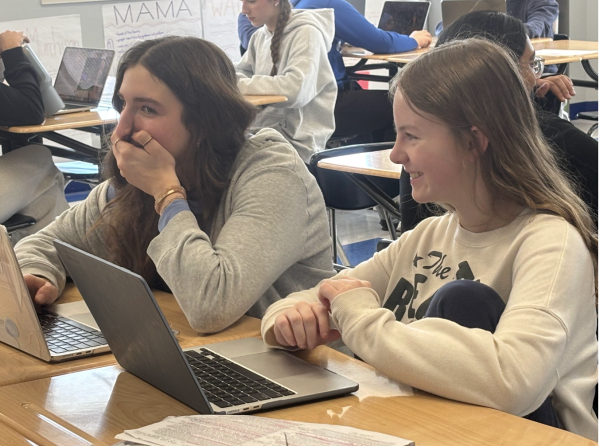 Caroline Palicki (10) and Stella Taylor (10)  share a laugh during class.