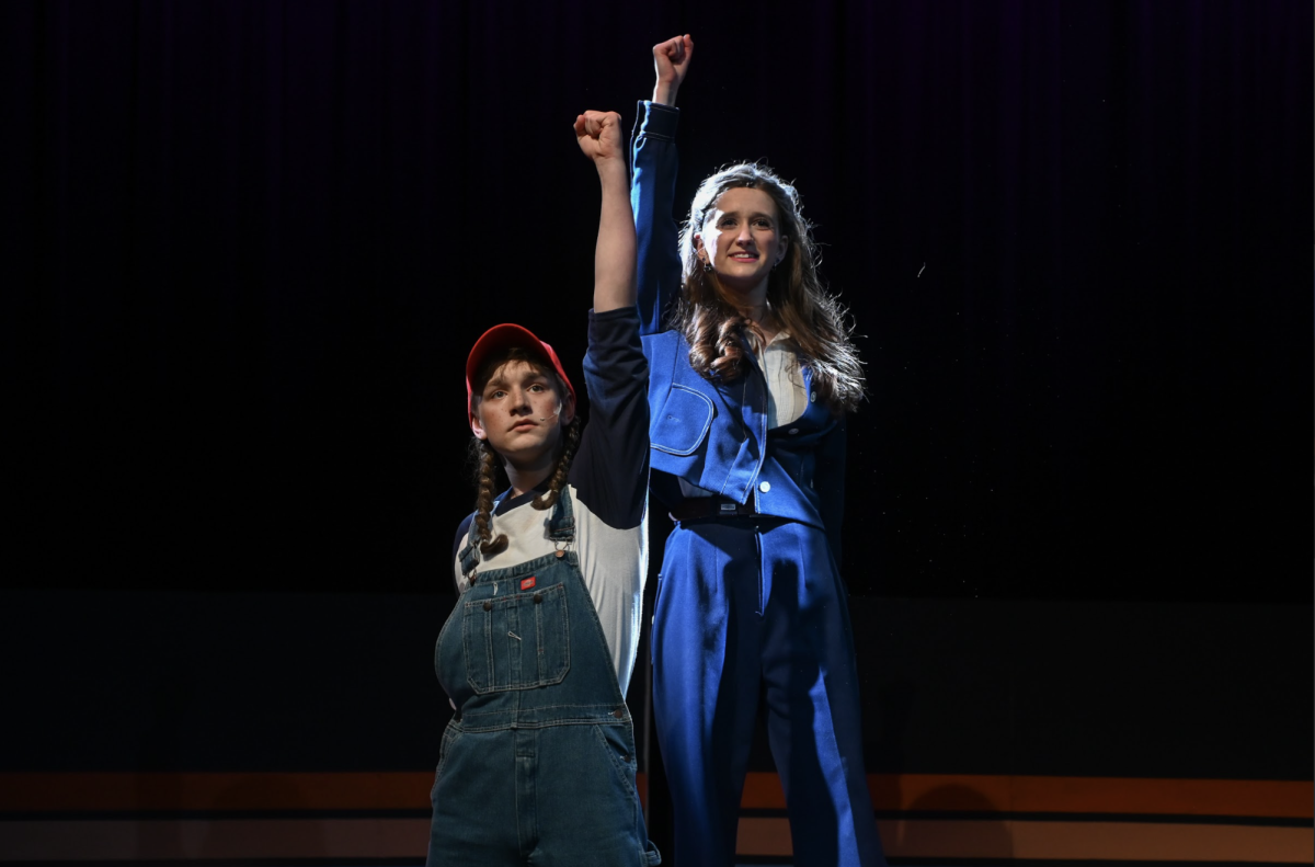 Emil Sztanyo (10) and Natalie Lorenz (12) raise fists up at the end of "I am Woman." "It was worth the work I put into this role,"  Sztanyo (10) said.