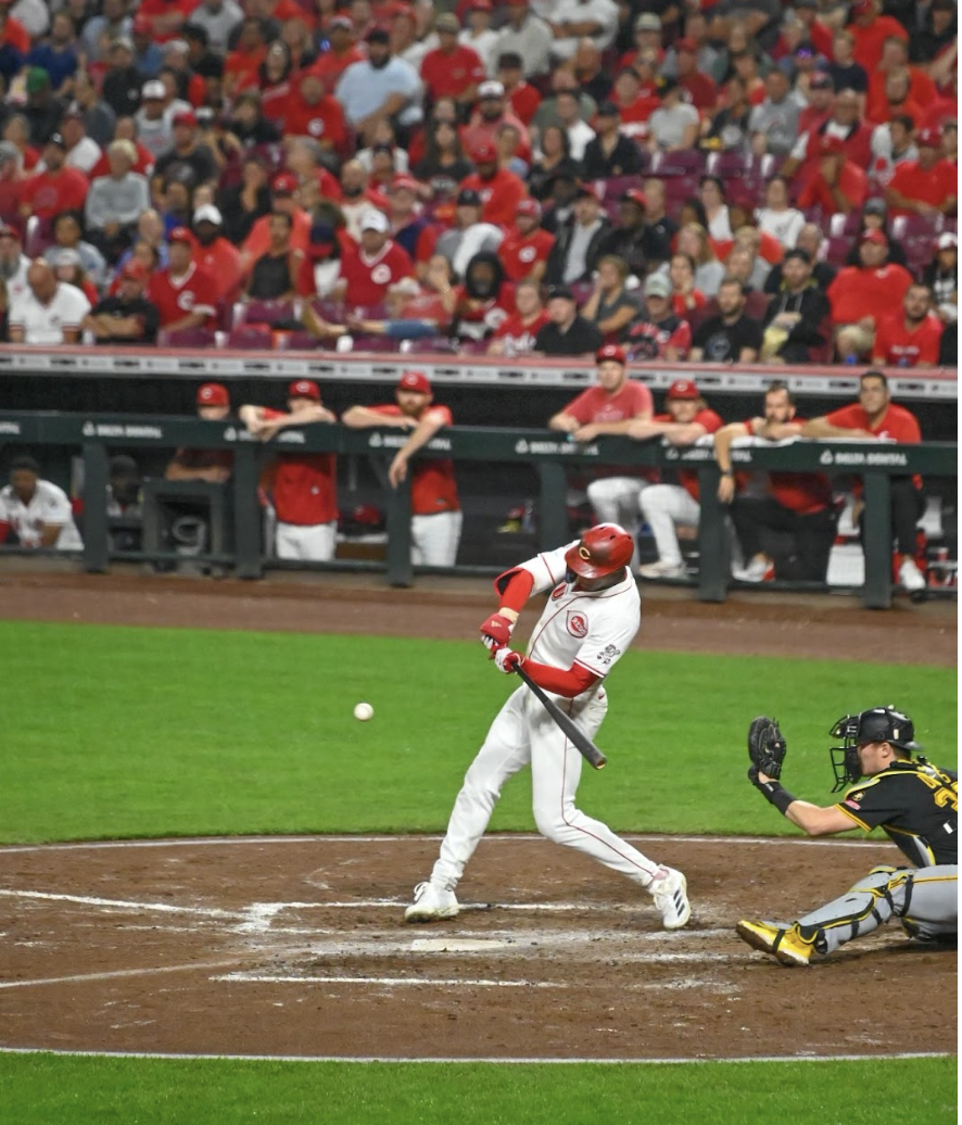 Reds player swings the bat at a pitch.