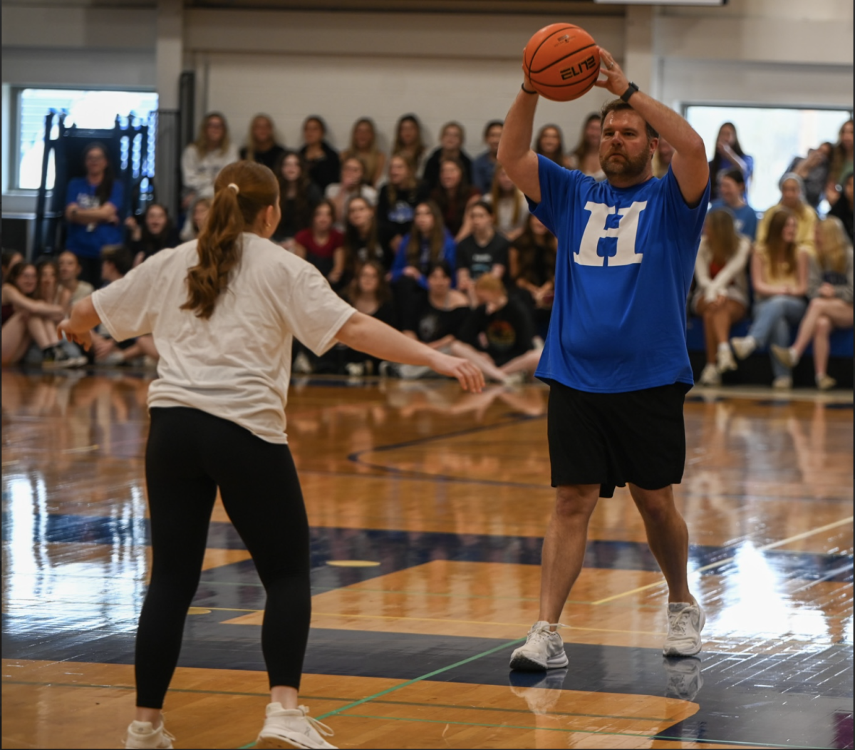 Maddie Barlow (12) blocks English Teacher Brady Dowling from the ball. “I think we were a lot more prepared than last year and it showed because we almost beat the teachers,” Barlow (12) said.