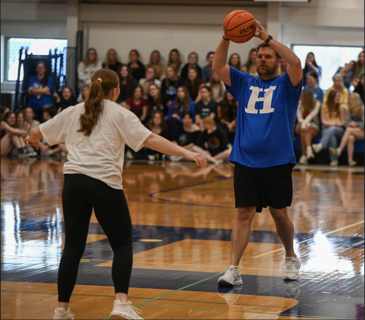 Maddie Barlow (12) blocks English Teacher Brady Dowling from the ball. “I think we were a lot more prepared than last year and it showed because we almost beat the teachers,” Barlow (12) said.