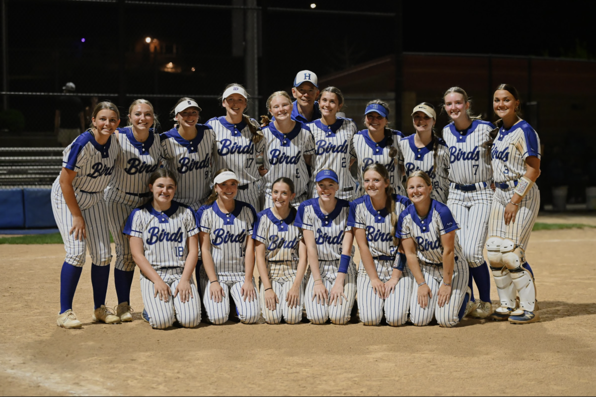 The Highlands varsity softball teams gets together for a photo under the lights.