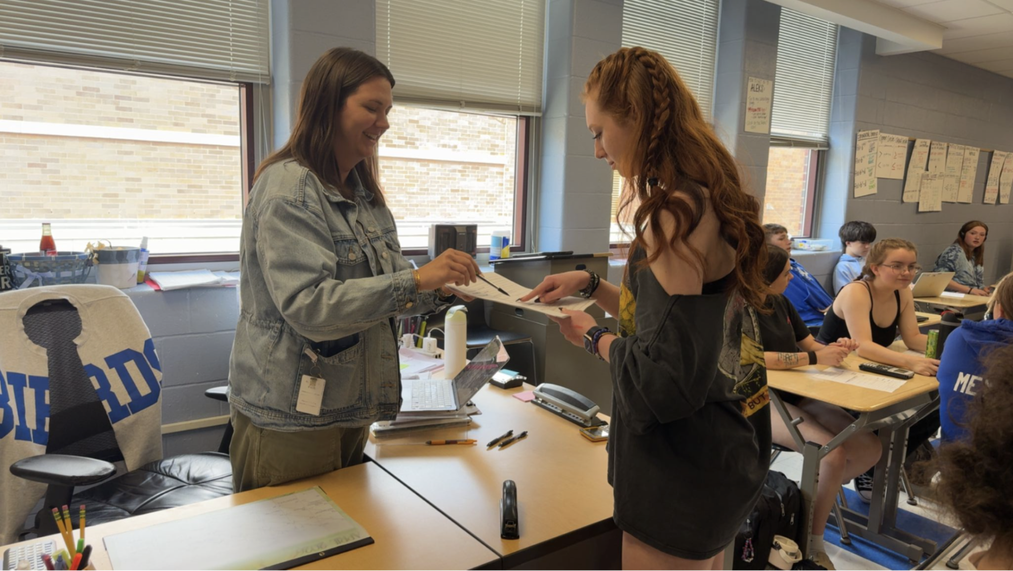 Abigail McCoy assists Gigi McFalls with work.