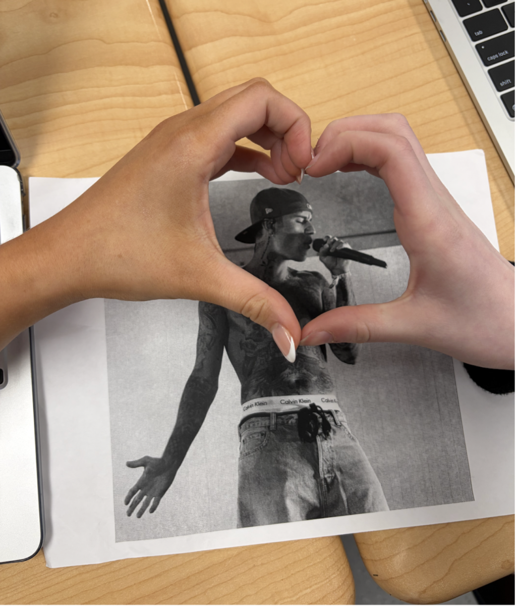 Students give a hand heart over Justin Bieber.