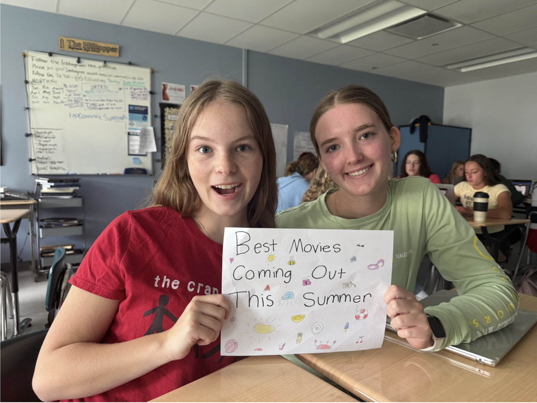 Stella Taylor (10) and Natalie Abdon (10) share the best movies coming out this summer with a sign.