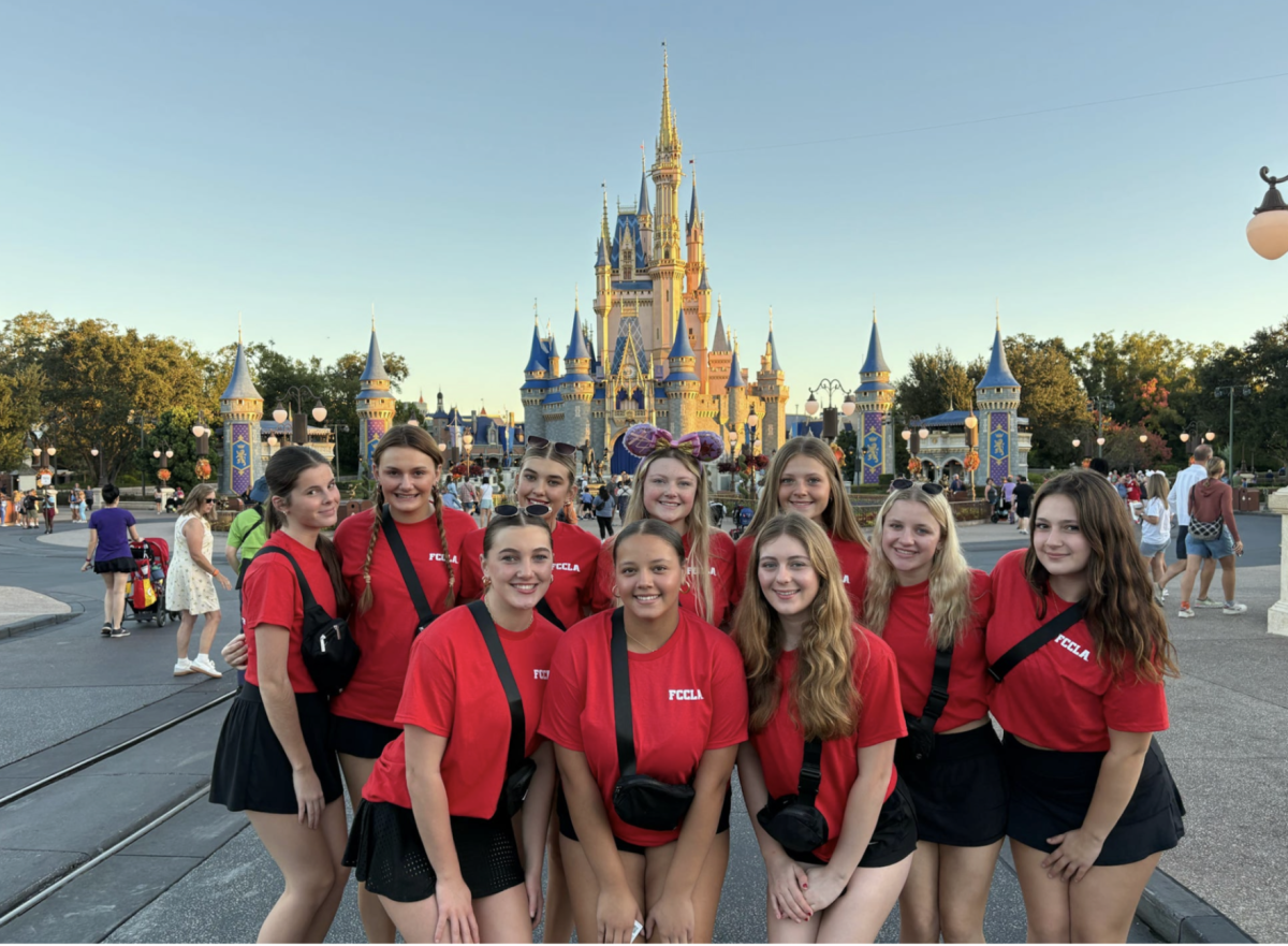 Ellie Rogiers (11), Lainey Wagner (11), Kenna Urlage (11), Addy Eiffert (12), Kaitlyn Dixon (12), Annie Kuhnein (12), Grace Burnett (12), Kendall Shields (11), Cydni Martin (12) and Penelope Kolb (12) pose for a group photo in Orlando, Florida, during National Fall Institute. (Courtesy of Ahren Wagner).