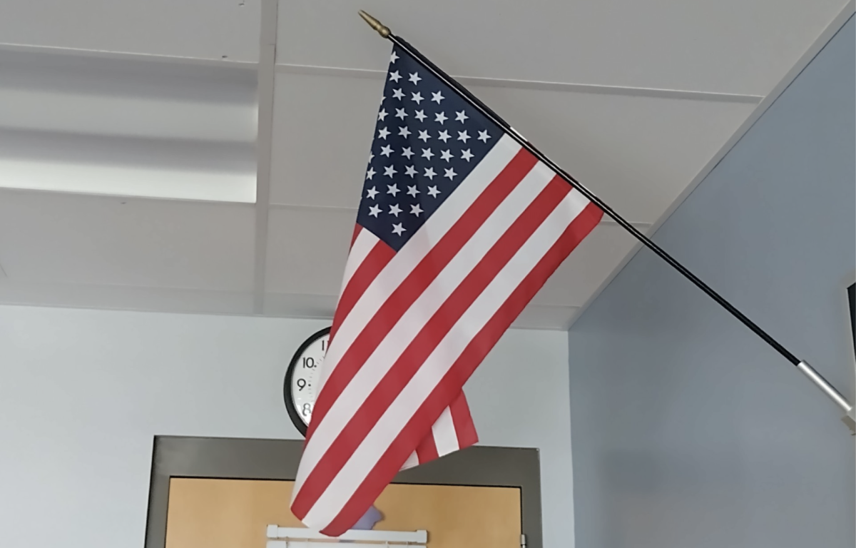 An American flag hanging in a classroom. 