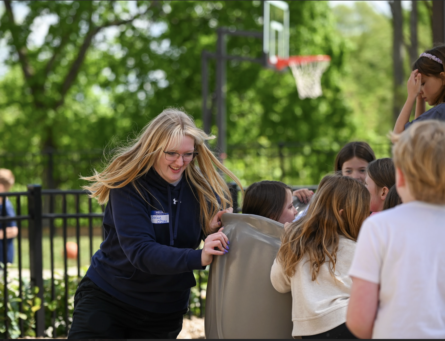 Bailey O'Day (12) spins the students on the merry-go-round. "It was really cool to see how much Johnson has changed. I went there with the first building so seeing all of the changes was really nice and seeing all of the teachers was really fun," O'Day (12) said.