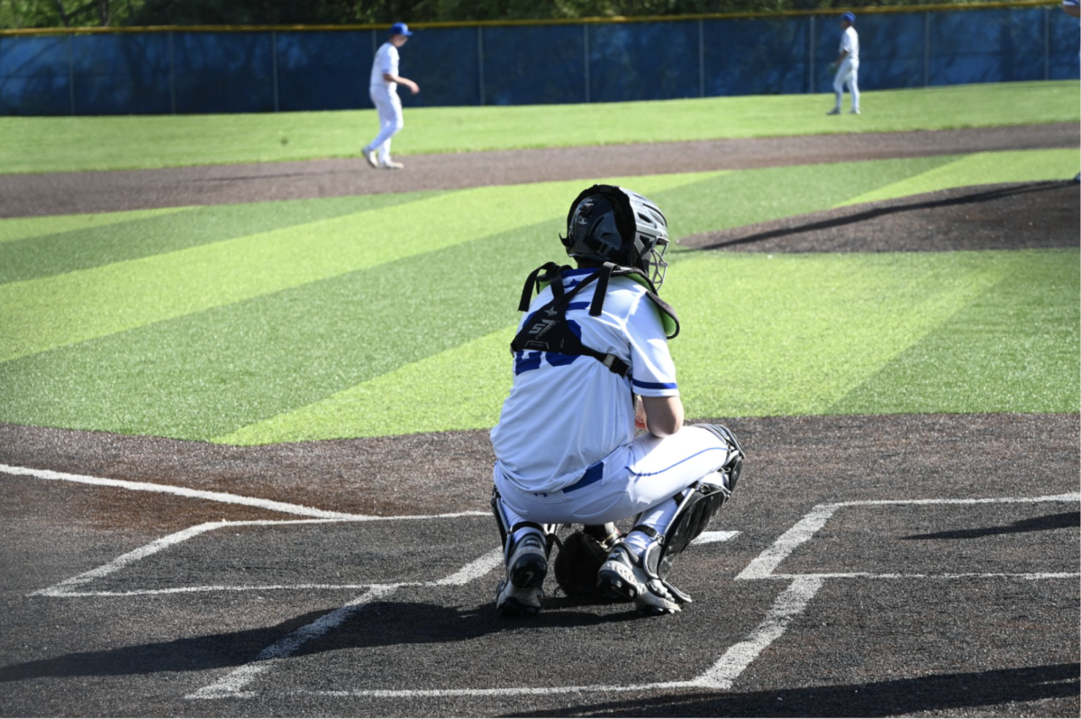 Andrew Myers (10) warms up with teammates before the next innings.