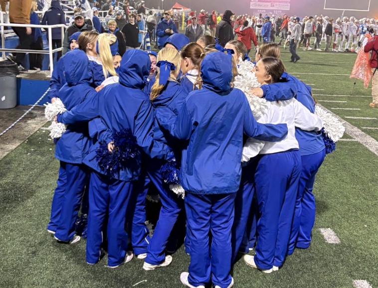 The varsity cheerleaders hug at their last football game together as a team.
Photo courtesy of Sarah Hoffman
